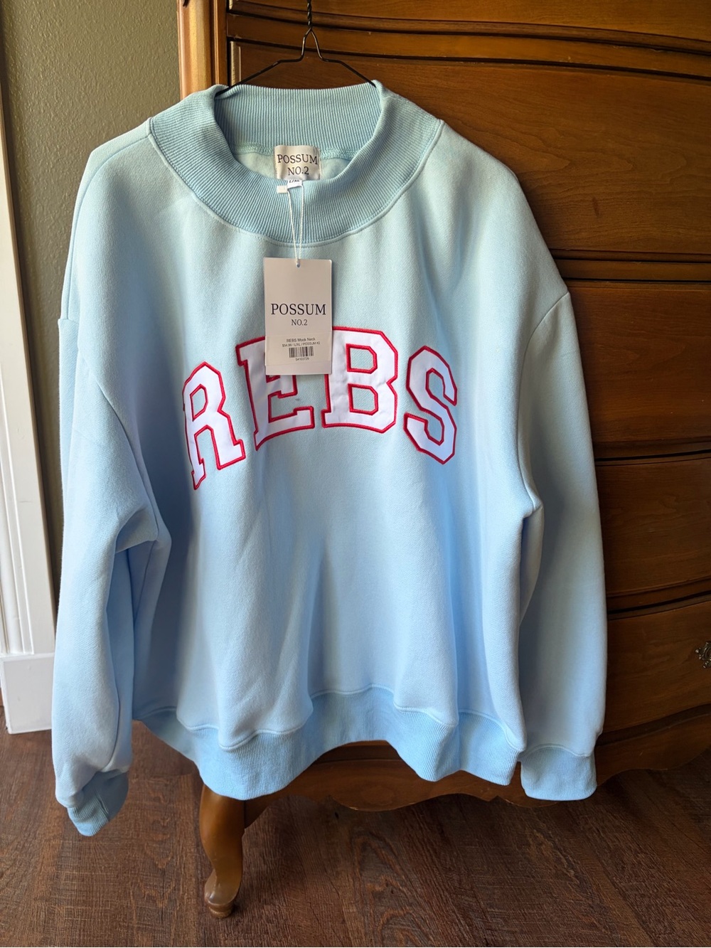 Light Blue Crewneck Sweater with Red 'REBS' Embroidery